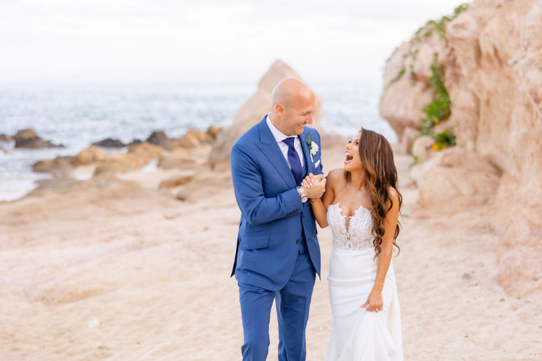 A bride and groom by the beach at their luxury wedding
