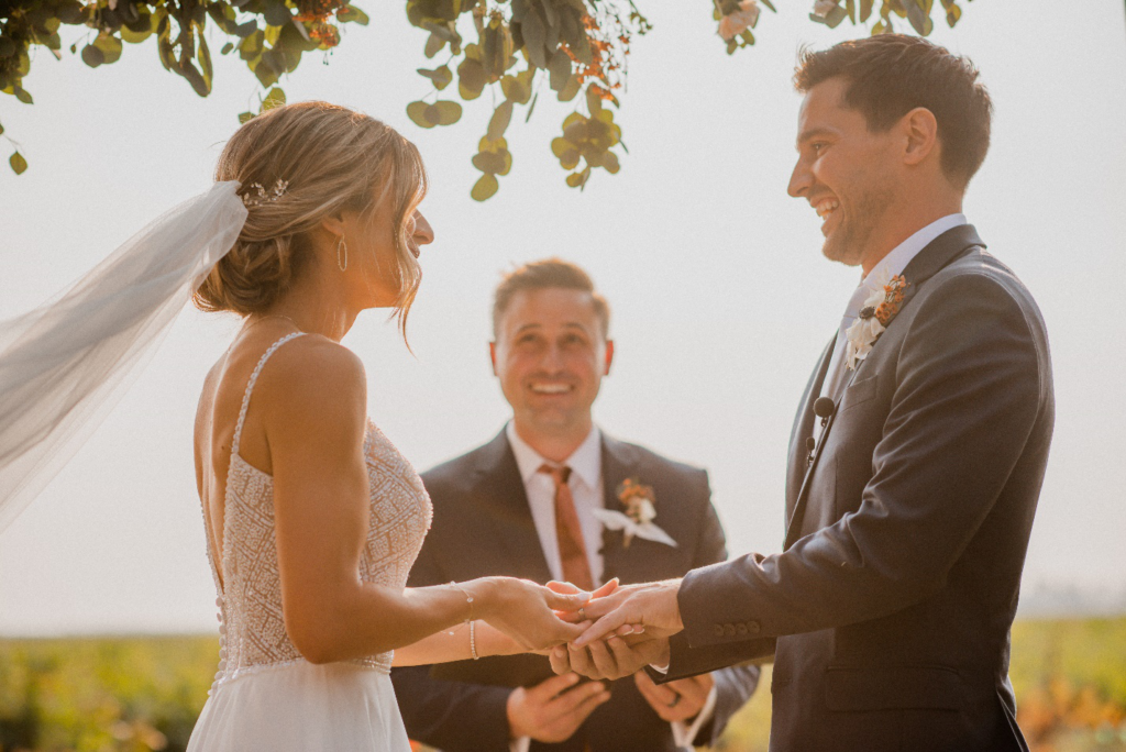 A couple standing with a minister at the altar of their luxury wedding