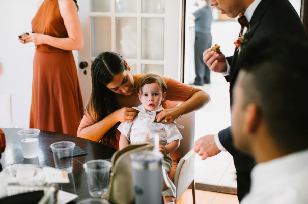 A mother dressing her child for a destination wedding