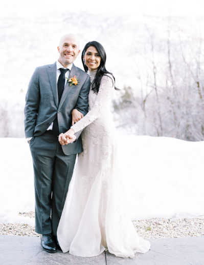 Bride and groom share a candid moment at their luxury winter wedding.