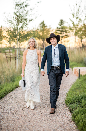 Bride and groom elegantly holding cowboy hats, embracing Nashville’s sophisticated Southern charm