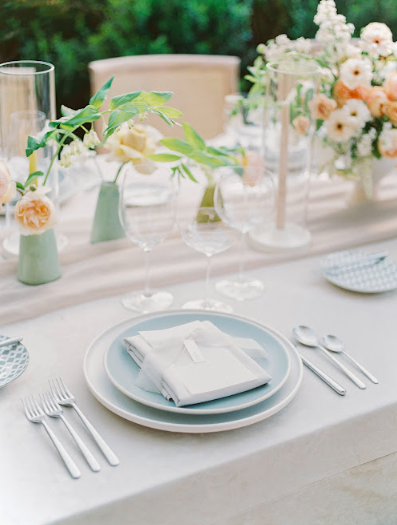 Luxurious wedding reception setup with elegantly arranged tables, floral centerpieces, and ambient lighting in a grand NYC venue