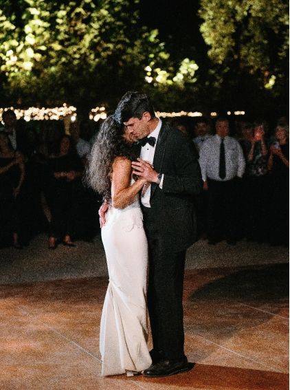 An image of a bride and groom dancing