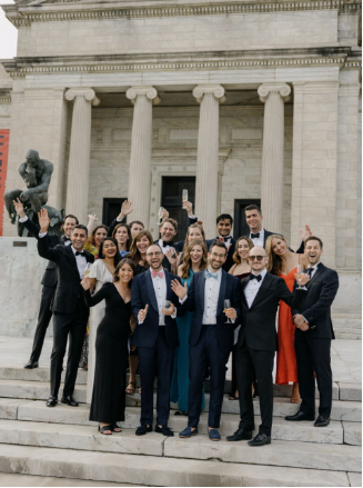Guests posing for the camera during a wedding.