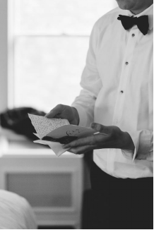 An image of a groom reading his speech
