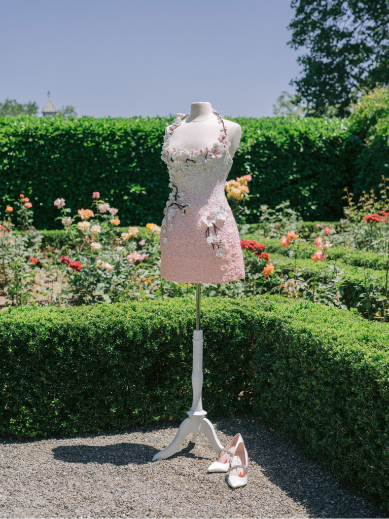 A dress with heels with a garden backdrop.