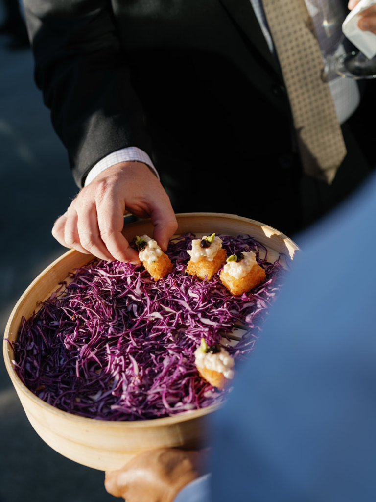 a guest having a snack at a wedding.