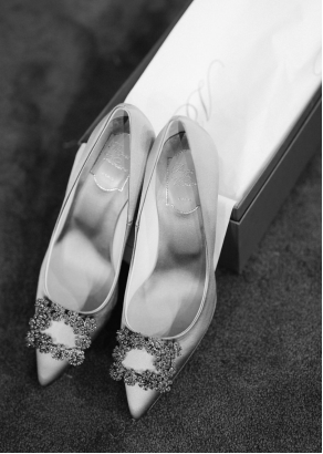 Pair of embellished bridal shoes arranged in a shoebox (black and white).