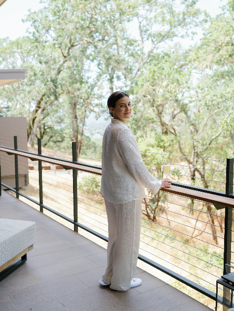 An image of a woman preparing for restful sleep before her wedding, standing on a balcony