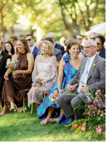 An image of wedding guests sitting outdoors