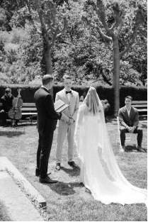 An image of a bride and groom standing at the altar