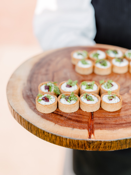 food carefully arranged on a wooden serving dish.