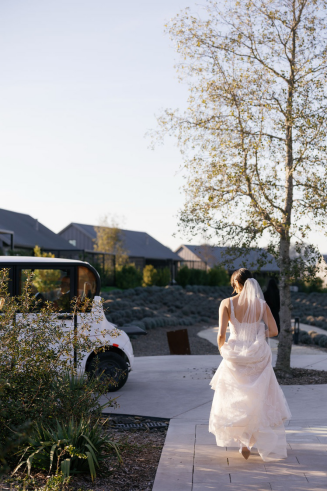 a bride standing outdoors with her veil