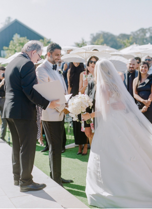 a bride standing next to the groom at a wedding reception.