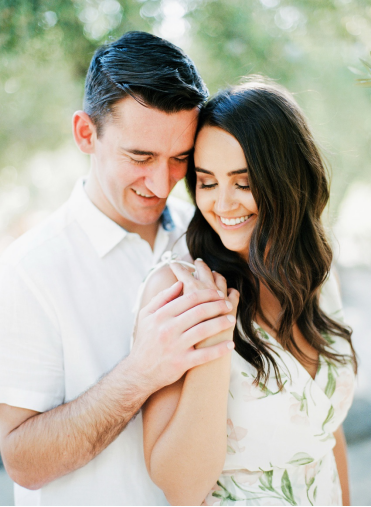 a bride and groom at their engagement shoot outdoors.