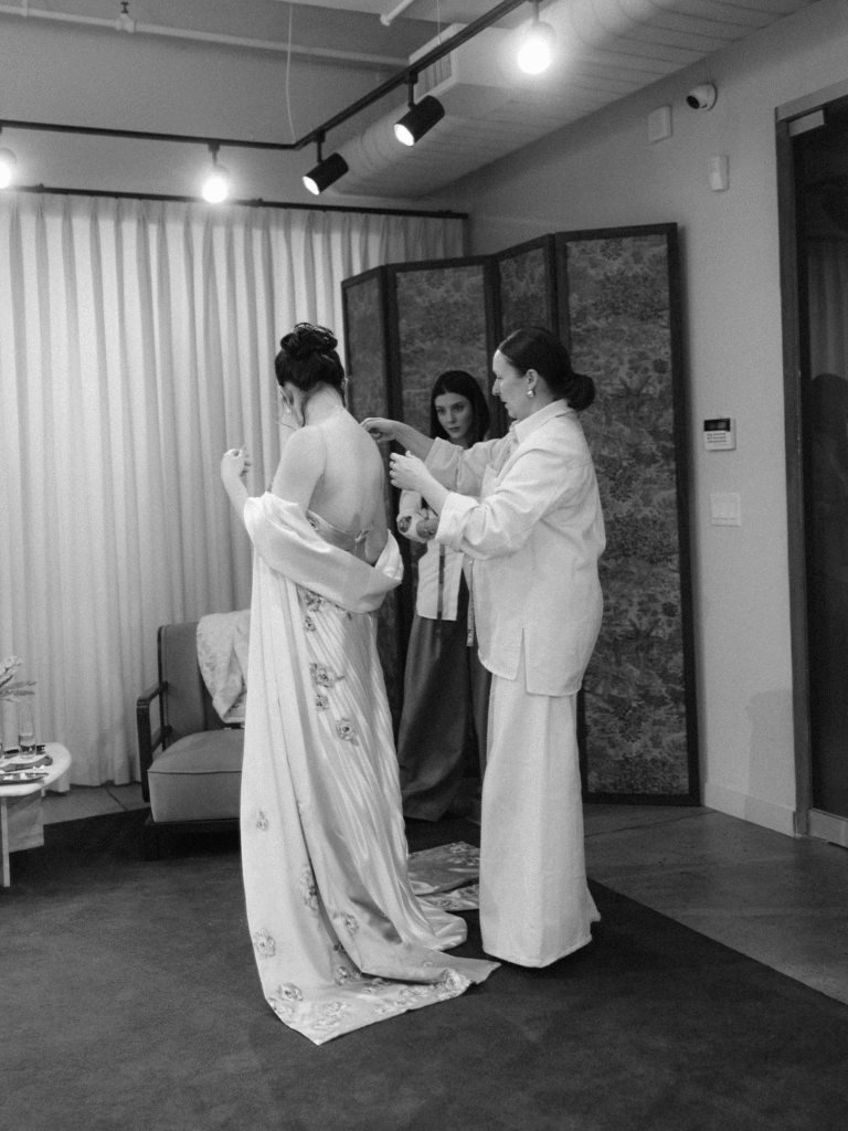 Bride trying on a gown with support during a fitting