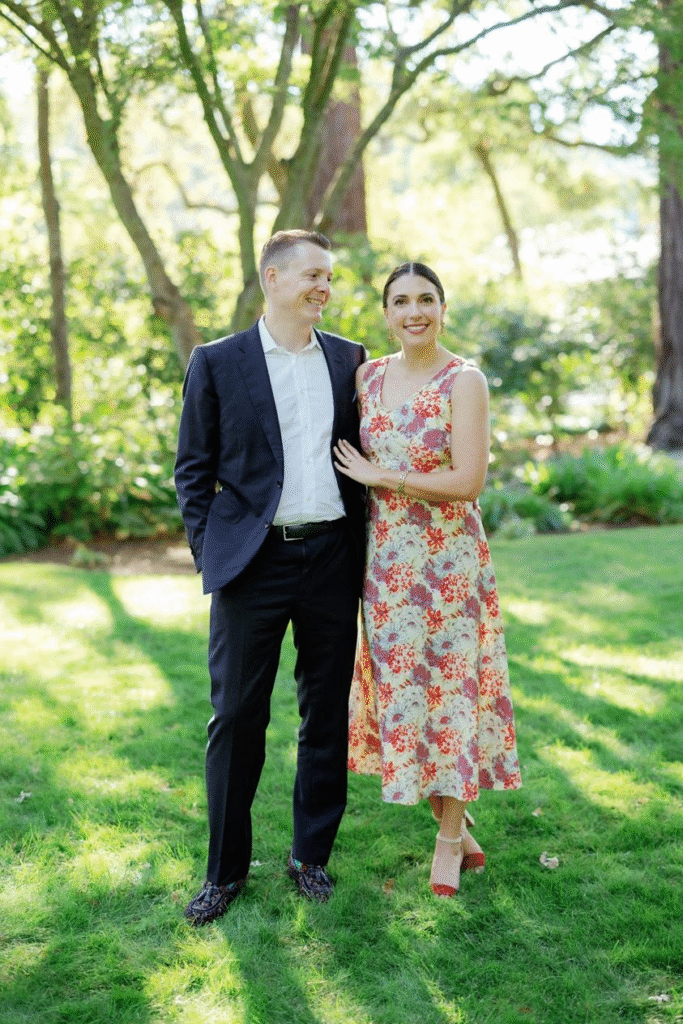 wedding guests standing outdoors in a botanical setting.