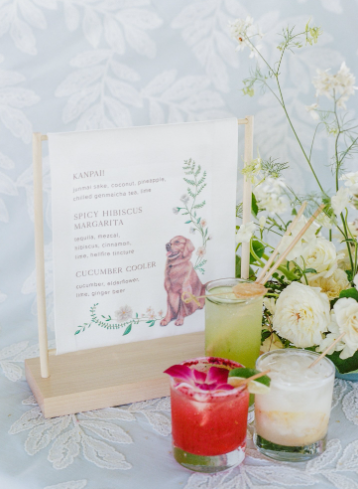A curated menu displayed on a stand with candles and décor can subtly personalize your wedding.