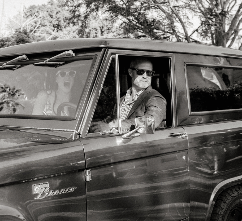 a bride and a groom in a car.
