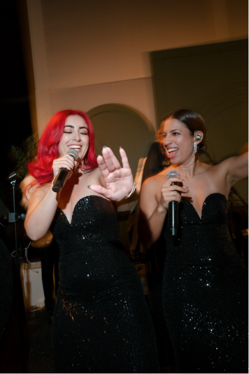 Two wedding performers singing at an event.