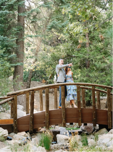 a bride and groom standing outdoors in nature