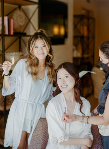 A bride and her bridesmaid getting ready