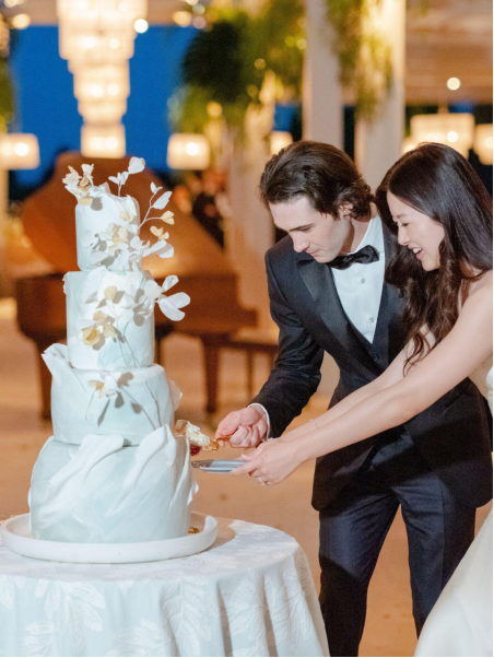A couple cuts a wedding cake