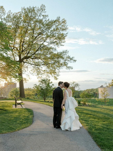 Bride and groom about to kiss in a park at sunset, capturing a romantic NYC wedding moment