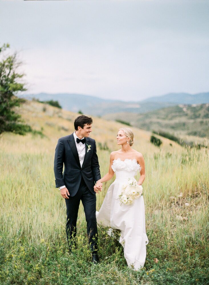 bride in a white gown taking a walk.