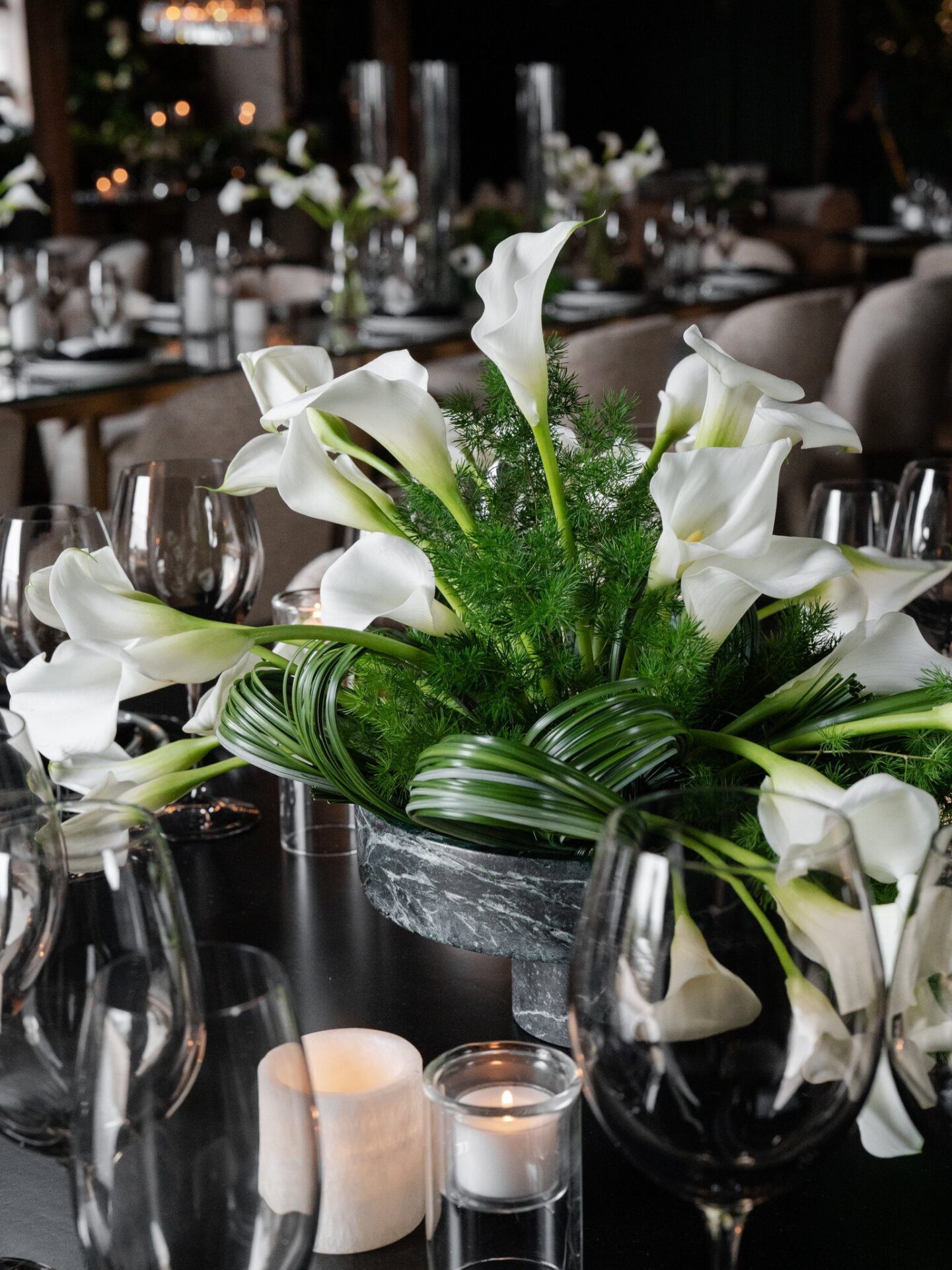 wedding decor with flowers and wooden chairs.