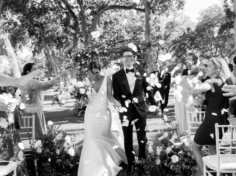 A newlywed couple walking down the aisle.