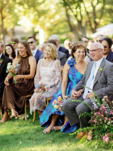 An image of wedding guests sitting outdoors