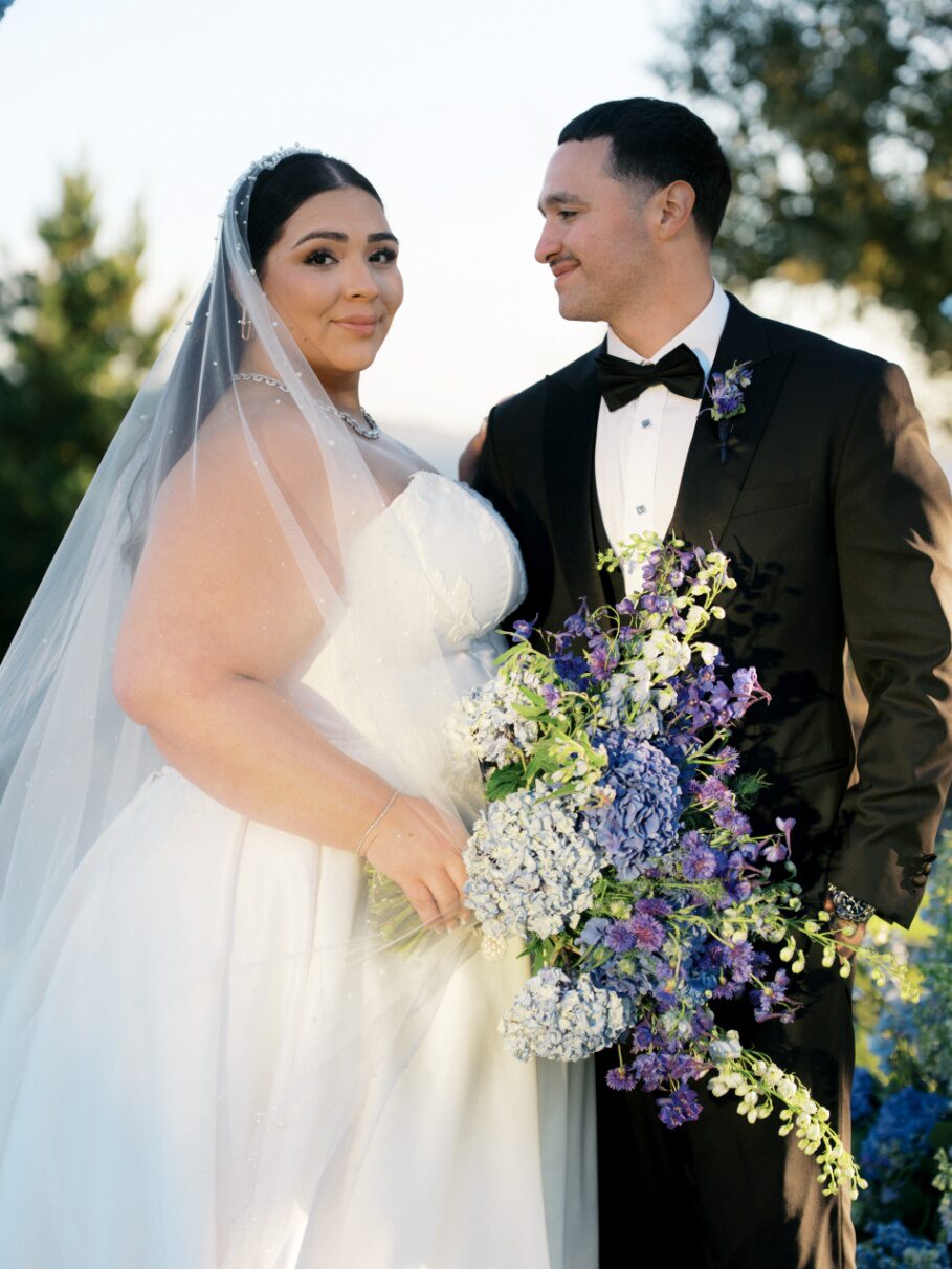 a bride and groom standing together.
