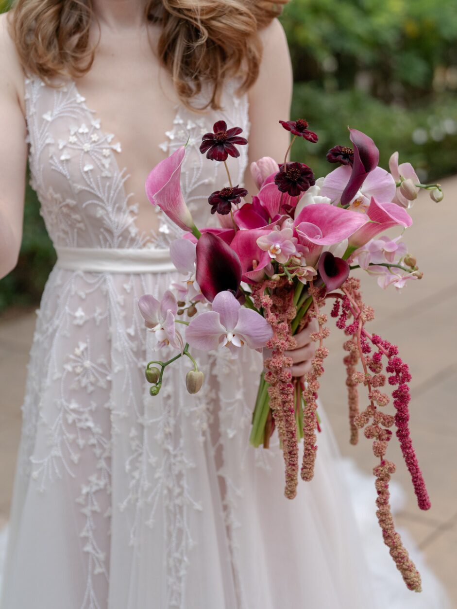 a bride holding a colorful bouquet.