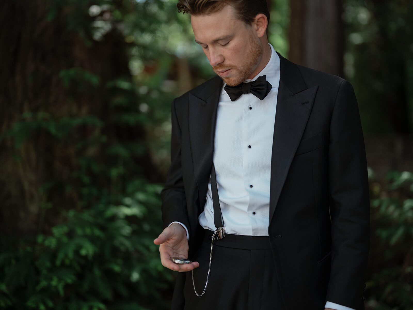 a groom in black tie attire.